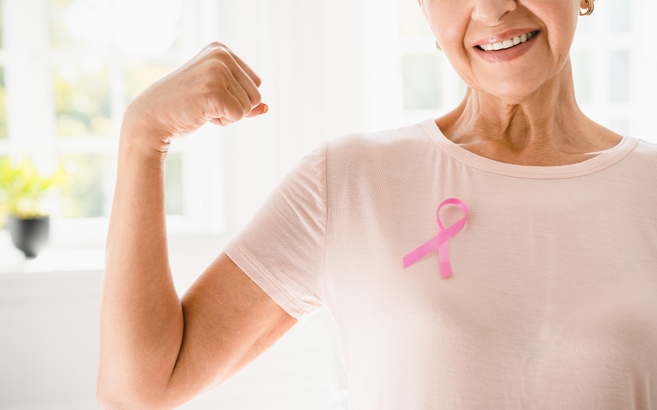 A woman wearing a breast cancer awareness ribbon.