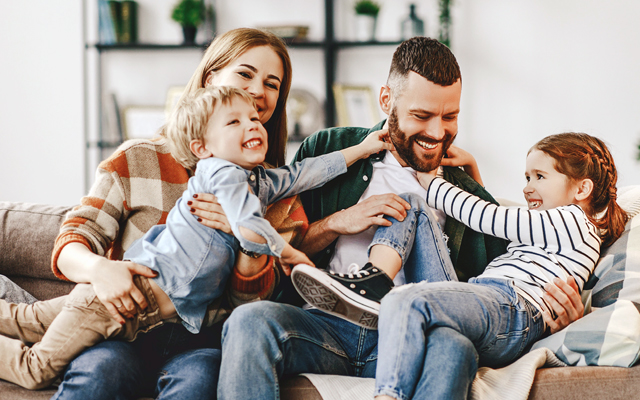 Parents with two kids on a couch