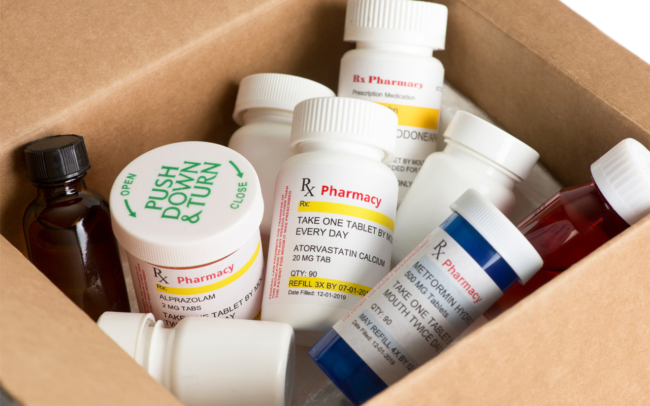 Pill bottles in a cardboard box