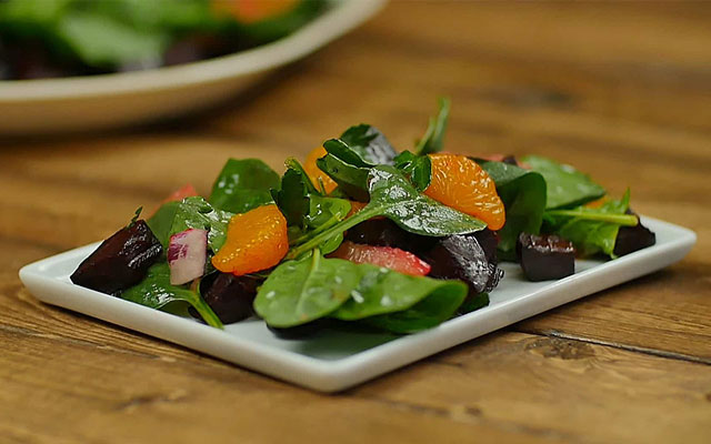 Fresh spinach leaves tossed with roasted beets, mandarin oranges, and ruby red grapefruit slices