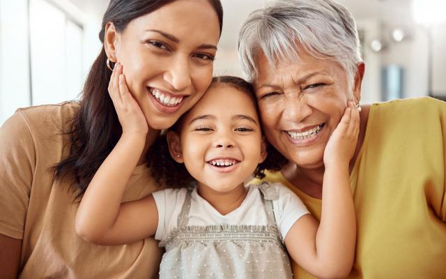 Grandmother, mother, and little girl smiling