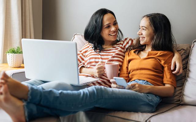 Mother and daughter talking on the couch