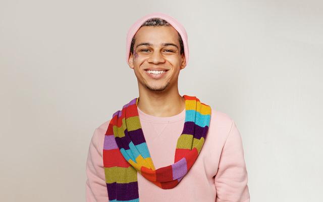 Young man with rainbow scarf