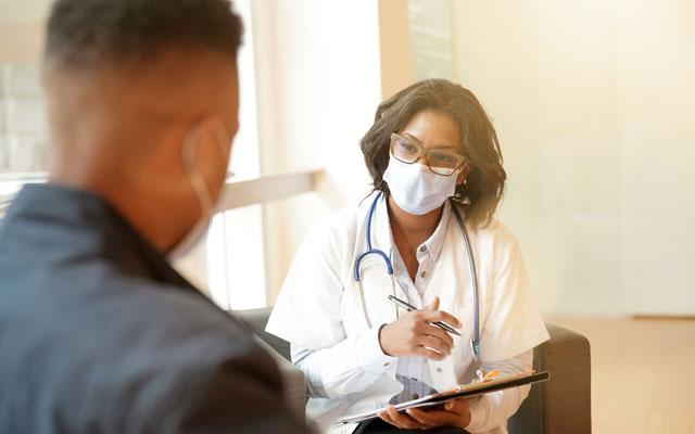 Masked doctor and patient