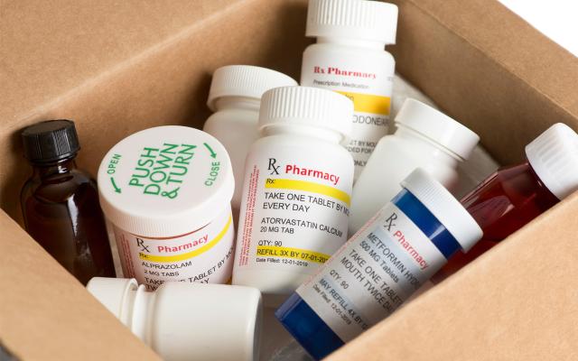 Pill bottles in a cardboard box